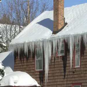 Ice dams forming on a Maine home roof during winter